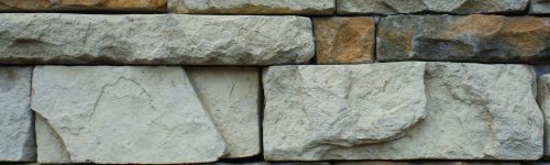 Finished Stone Veneer wall showing different sizes and color stones and minimal gaps separating