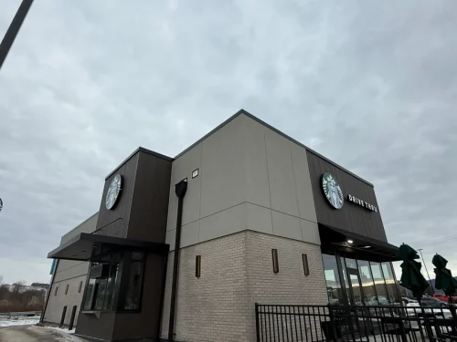 Photo of a Starbucks building with EIFS, thin brick, and fiber cement exterior cladding installed