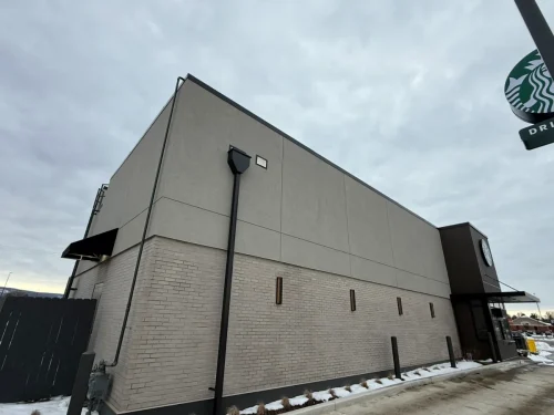 Photo of a Starbucks building with EIFS, thin brick, and fiber cement exterior cladding installed