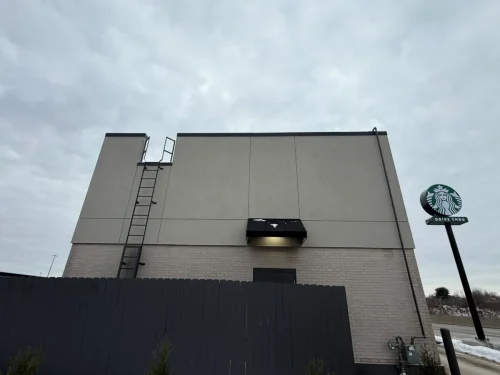 Photo of a Starbucks building with EIFS, thin brick, and fiber cement exterior cladding installed
